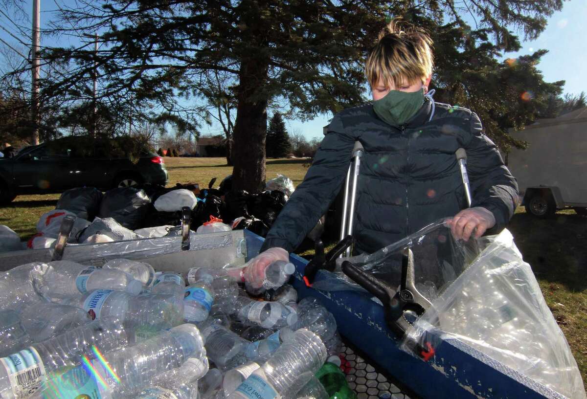 Boy Scout Troop 25 holds its monthly redeemable bottle and can drive at First United Methodist Church in Shelton, Conn., on Saturday Jan. 9, 2021. The event, which helps raise money for scouting activities, is held each first Saturday of each month from 10 a.m. to 1 p.m.