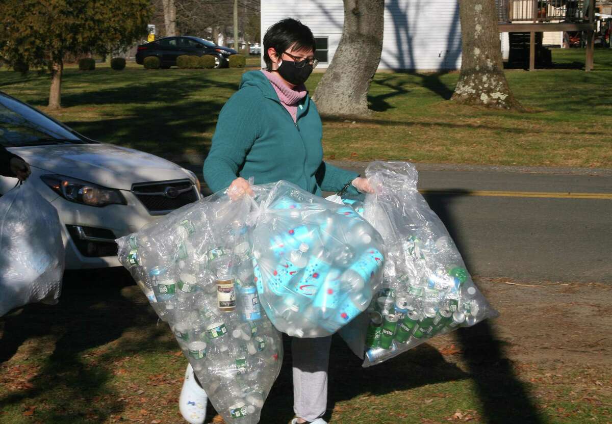 Boy Scout Troop 25 holds its monthly redeemable bottle and can drive at First United Methodist Church in Shelton, Conn., on Saturday Jan. 9, 2021. The event, which helps raise money for scouting activities, is held each first Saturday of each month from 10 a.m. to 1 p.m.