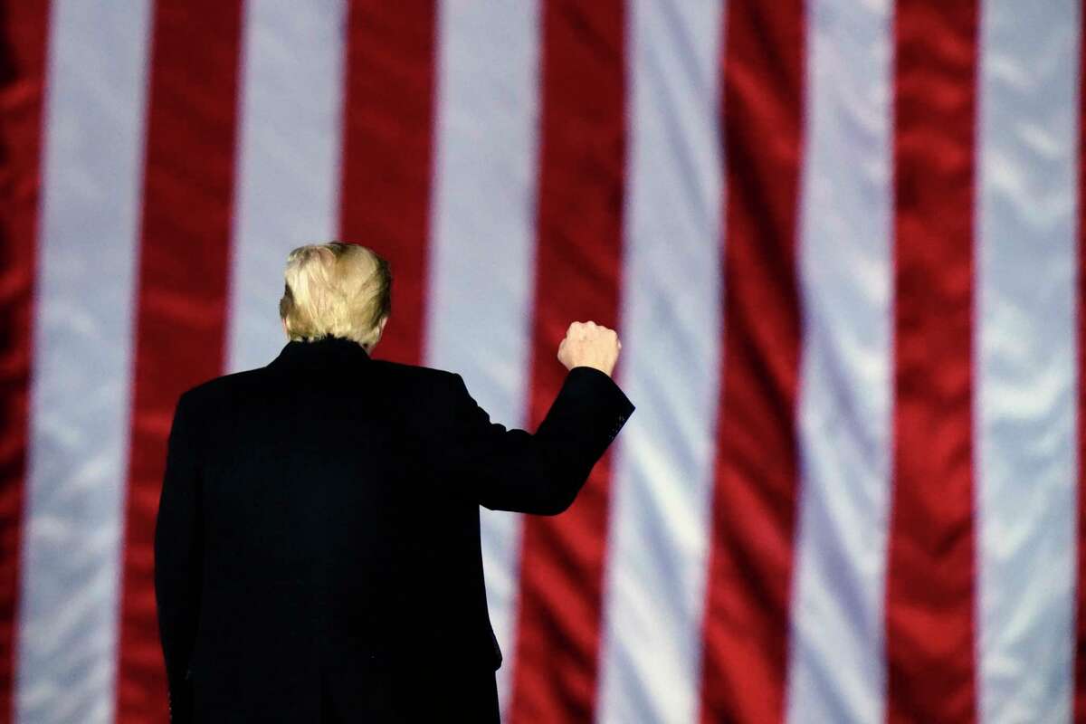 In this Monday, Jan. 4, 2021, file photo, President Donald Trump gestures at a campaign rally in support of Senate candidates Sen. Kelly Loeffler, R-Ga., and David Perdue in Dalton, Ga. Trump will travel to Texas on Tuesday, Jan. 12, 2021, to trumpet one of the pillars of his presidency: his campaign against illegal immigration.