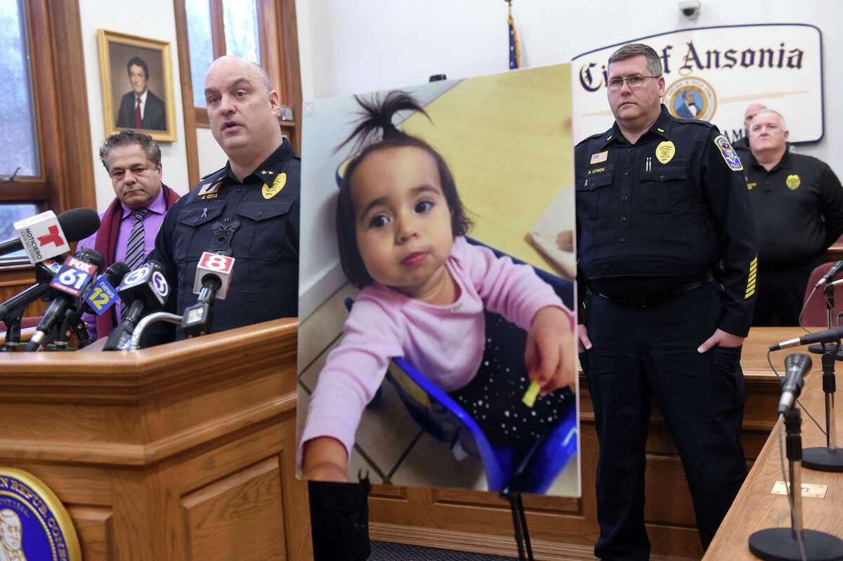 Ansonia Police Chief Andrew Cota, III, (left) speaks at a press conference at Ansonia City Hall on February 7, 2020 announcing charges or murder and tampering with evidence for Jose Morales related to the homicide of Christine Holloway. At right is a photograph of Halloway's missing 1-year-old daughter, Vanessa Morales.