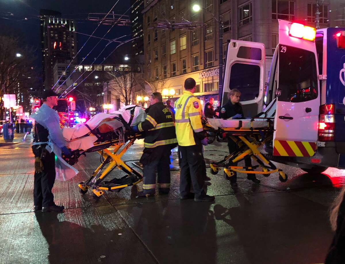 SEATTLE, WA - JANUARY 22: EMT and Police give first aid to a shooting victim in downtown on January 22, 2020 in Seattle, Washington. As many as seven people have been reportedly injured and police are still searching for the suspect. (Photo by Chris Porter/Getty Images)