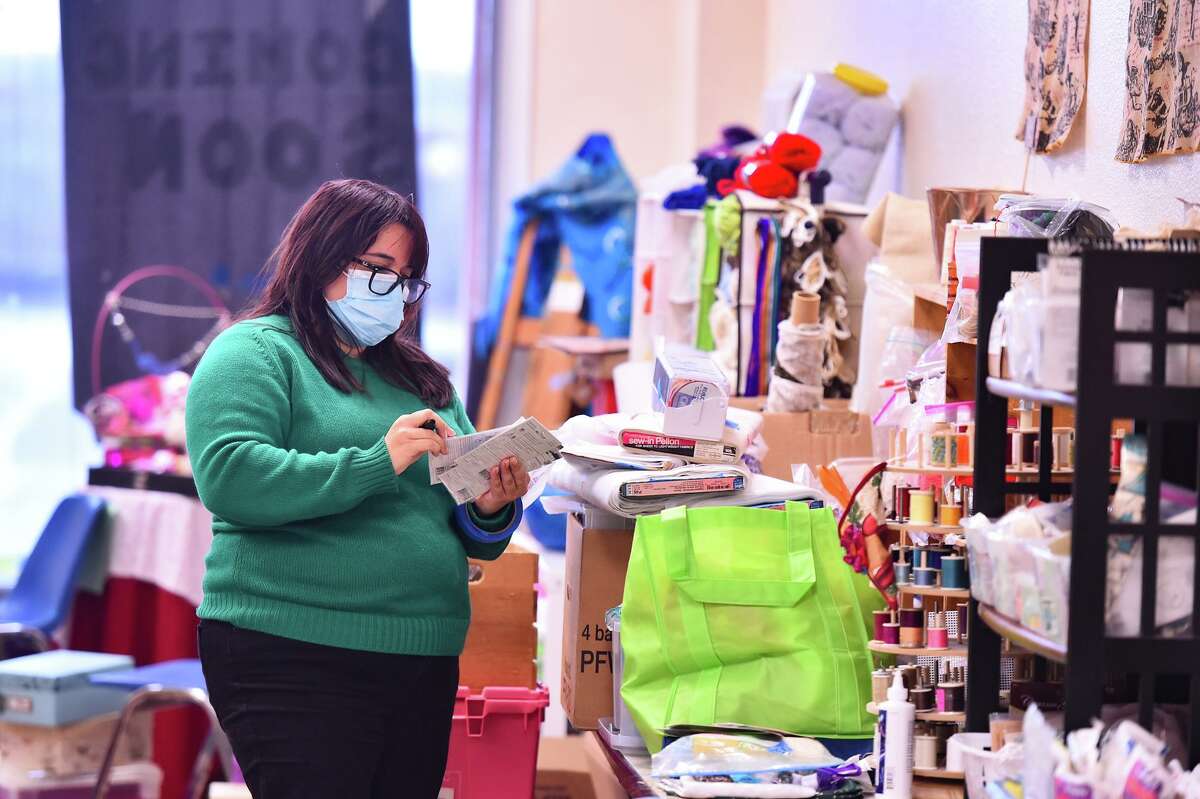 Mary Elizabeth Cantu, founder and executive director of Spare Parts, looks over donations of items that can be repurposed as art supplies. They are sold at the non-profit’s new Center for Creative Reuse.