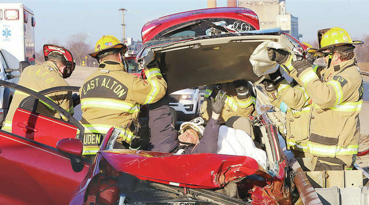 East Alton firefighters turned a Kia Rio into a convertible Tuesday morning to extricate the driver following a single-vehicle crash about 7:50 a.m. on Illinois 143. Authorities said the driver suffered facial lacerations and chest pains and, once extricated from the vehicle, was taken to a local hospital by Alton Memorial Ambulance paramedics. During the hour-long extrication East Alton Fire Chief Tim Quigley was inside the vehicle with the driver, who was covered with a sheet to keep glass and debris off of them.