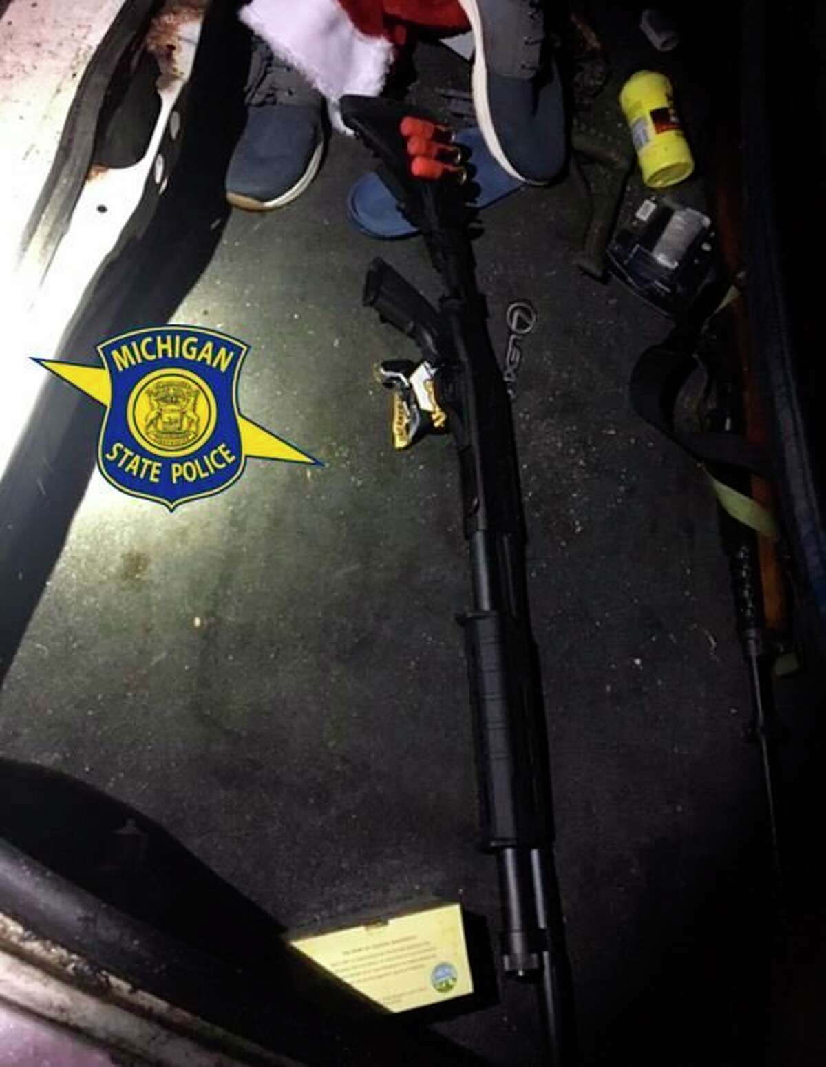 Police found three unloaded long guns in the trunk of a Lansing man's vehicle after responding to a car-deer collision call and finding the car's owner in the road and wielding a machete. (Courtesy Photo)