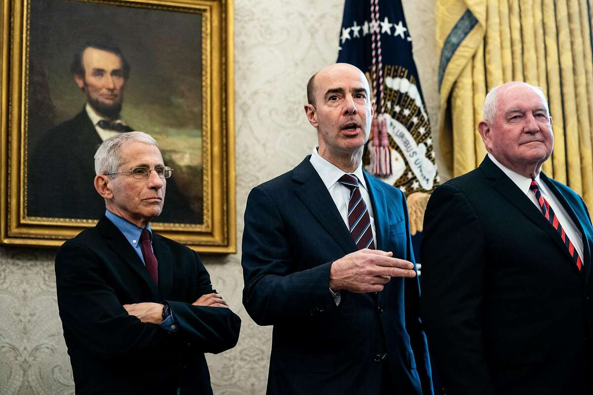 Secretary of Labor Eugene Scalia (center) attends a bill-signing ceremony in March. Under Scalia, the Department of Labor has sought to place restrictions on H-1B visas.
