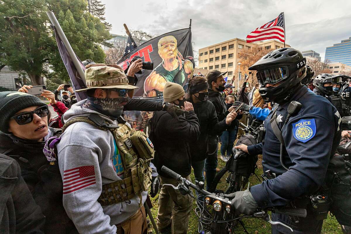 Supporters of President Trump face off against police at a rally in front of the California State Capitol building on Jan. 6.