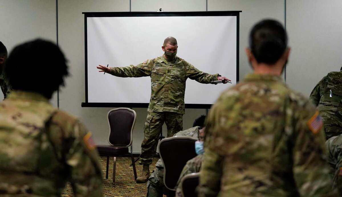 Sergeant Major of the Army Michael Grinston, center, gets feedback from soldiers about their concerns at Fort Hood, Texas, Thursday, Jan. 7, 2021. Following more than two dozen soldier deaths in 2020, including multiple homicides, the U.S. Army Base is facing an issue of distrust among soldiers. (AP Photo/Eric Gay)