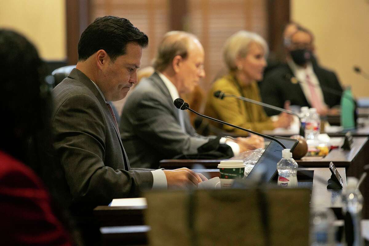 Bexar County commissioners including Justin Rodriguez, left, and Judge Nelson Wolff, second from left, discuss how to divide $1 million for domestic violence services.