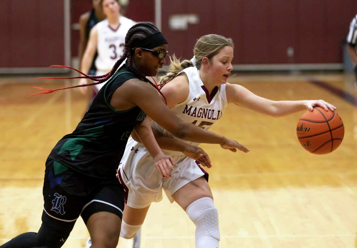 Magnolia guard Sydney Holland (15) loses control of the ball due to pressure from Bryan Rudder Tianna Mathis (20) during the first quarter of a District 19-5A girls basketball game at Magnolia High School, Tuesday, Jan 12, 2021, in Magnolia.