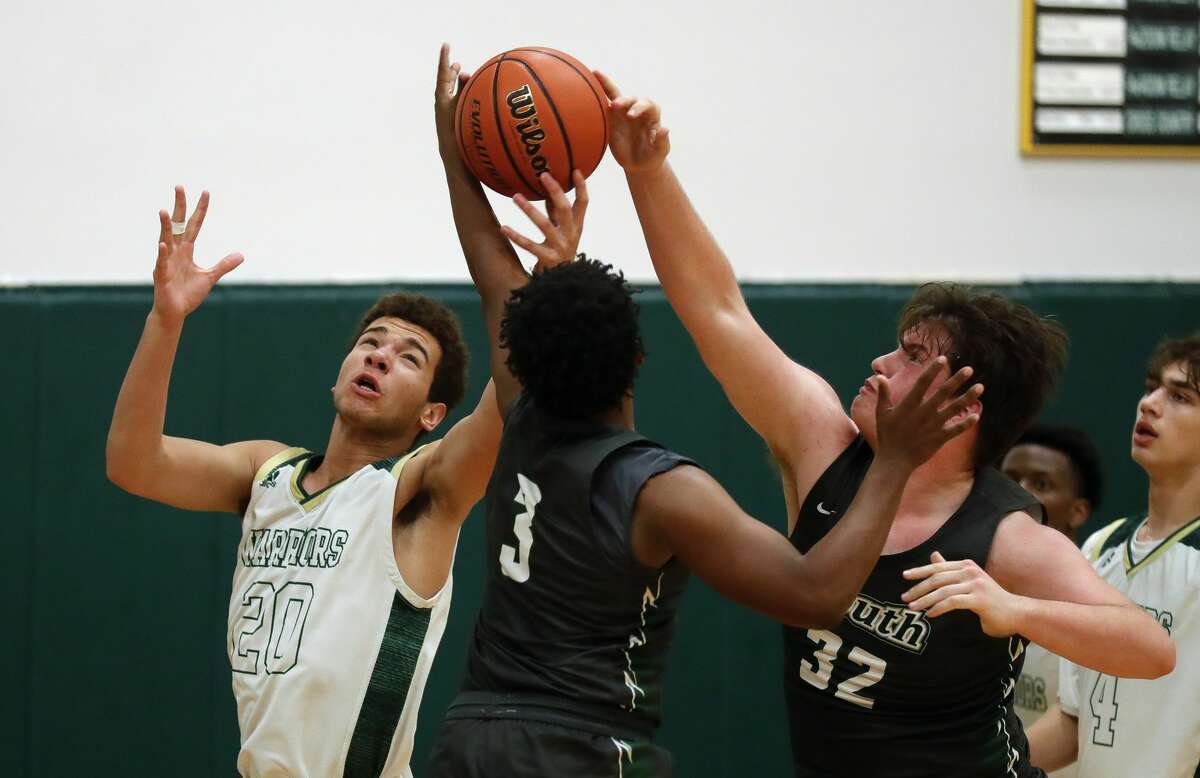 The Woodlands Christian Academy's Cedric Cook (20) fights for a loose ball against Lutheran South's Kamron Byrd (3) and Lane Whitney (32) during the fourth quarter of a TAPPS District 5-5A high school basketball game at The Woodlands Christian Academy, Tuesday, Jan. 12, 2021, in The Woodlands.