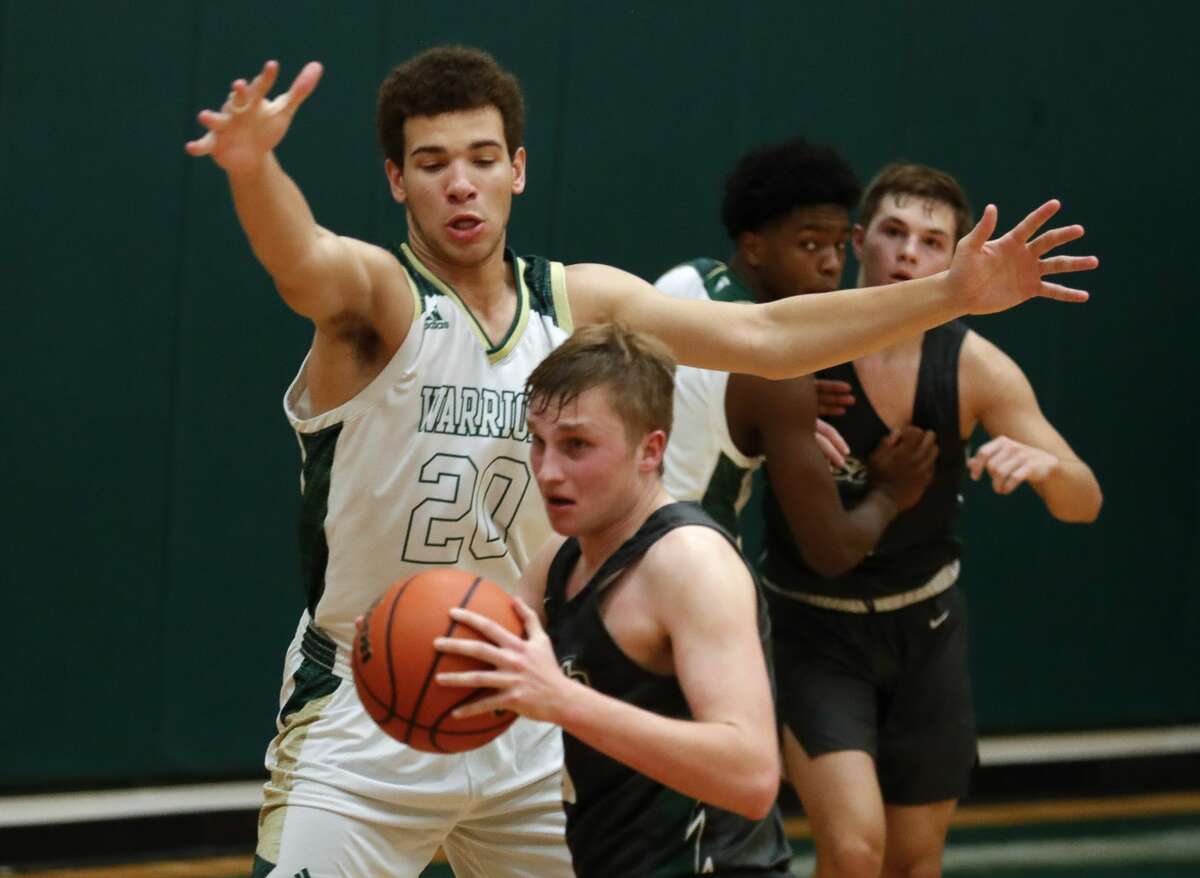 The Woodlands Christian Academy's Cedric Cook (20) pressures Lutheran South's Wyatt Maher (15) during the fourth quarter of a TAPPS District 5-5A high school basketball game at The Woodlands Christian Academy, Tuesday, Jan. 12, 2021, in The Woodlands.