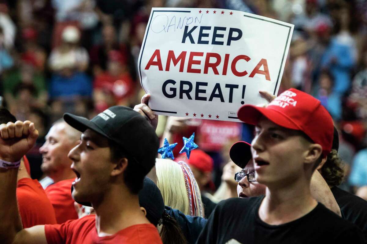Supporters cheer with a QAnon sign as President Donald Trump prepares to speak at a "Keep America Great Rally" on Aug. 1, 2019, in Cincinnati.