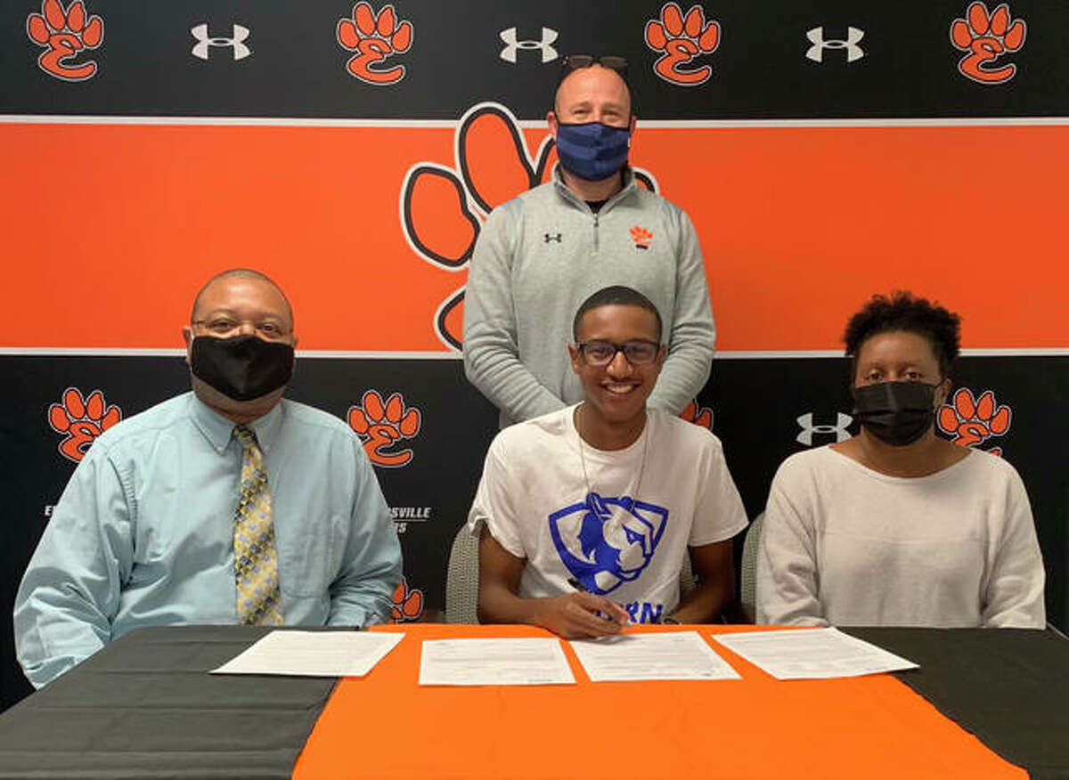Edwardsville High School senior Brandon Battle, seated center, will run men’s track and field at Eastern Illinois University. He is joined by his parents and EHS track and field coach Chad Lakatos.