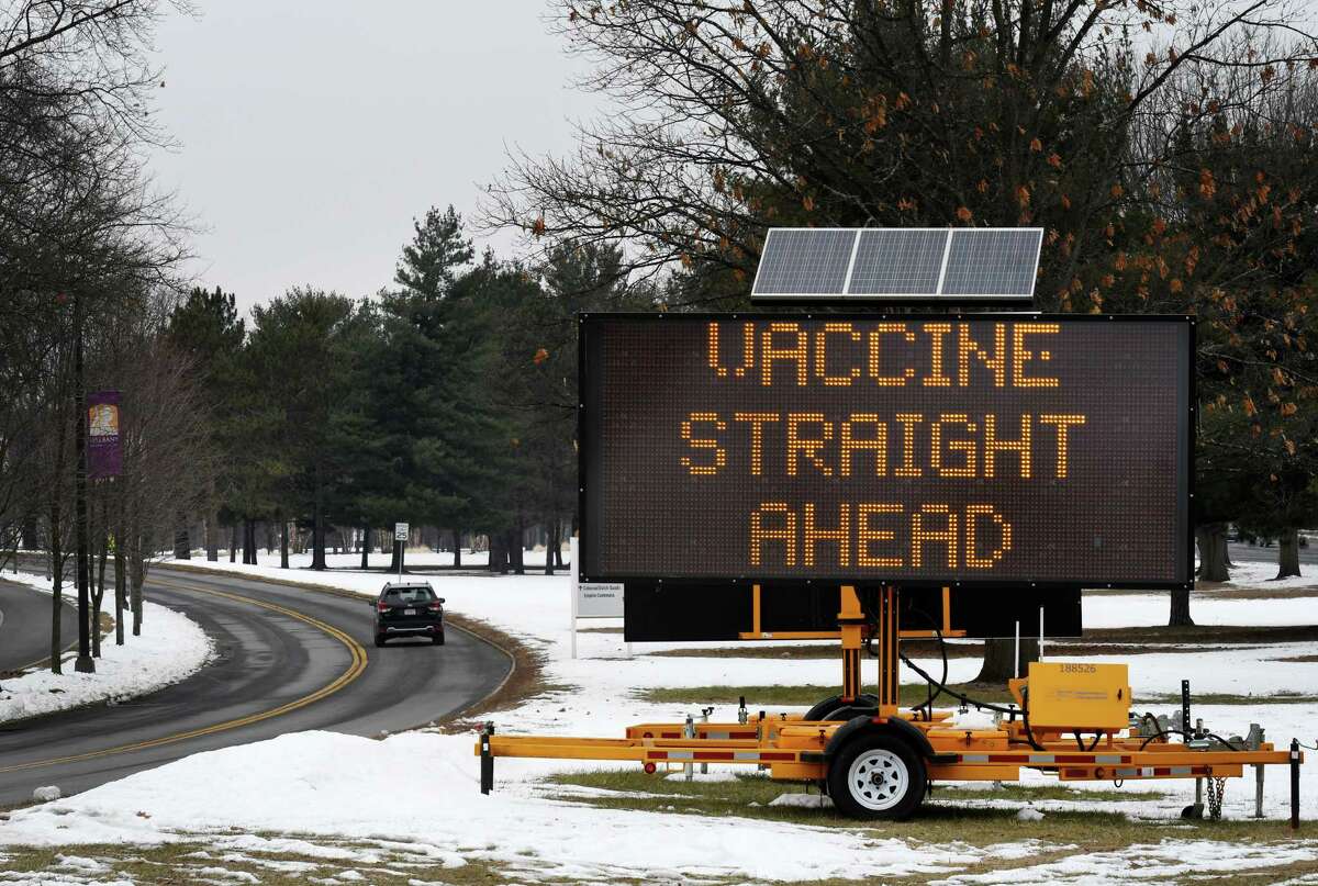 A sign on the University at Albany Campus directs traffic to the site of a new vaccine distribution center being built at the Northwest Gold parking lot on Wednesday, Jan. 13, 2021, in Albany, N.Y. (Will Waldron/Times Union)