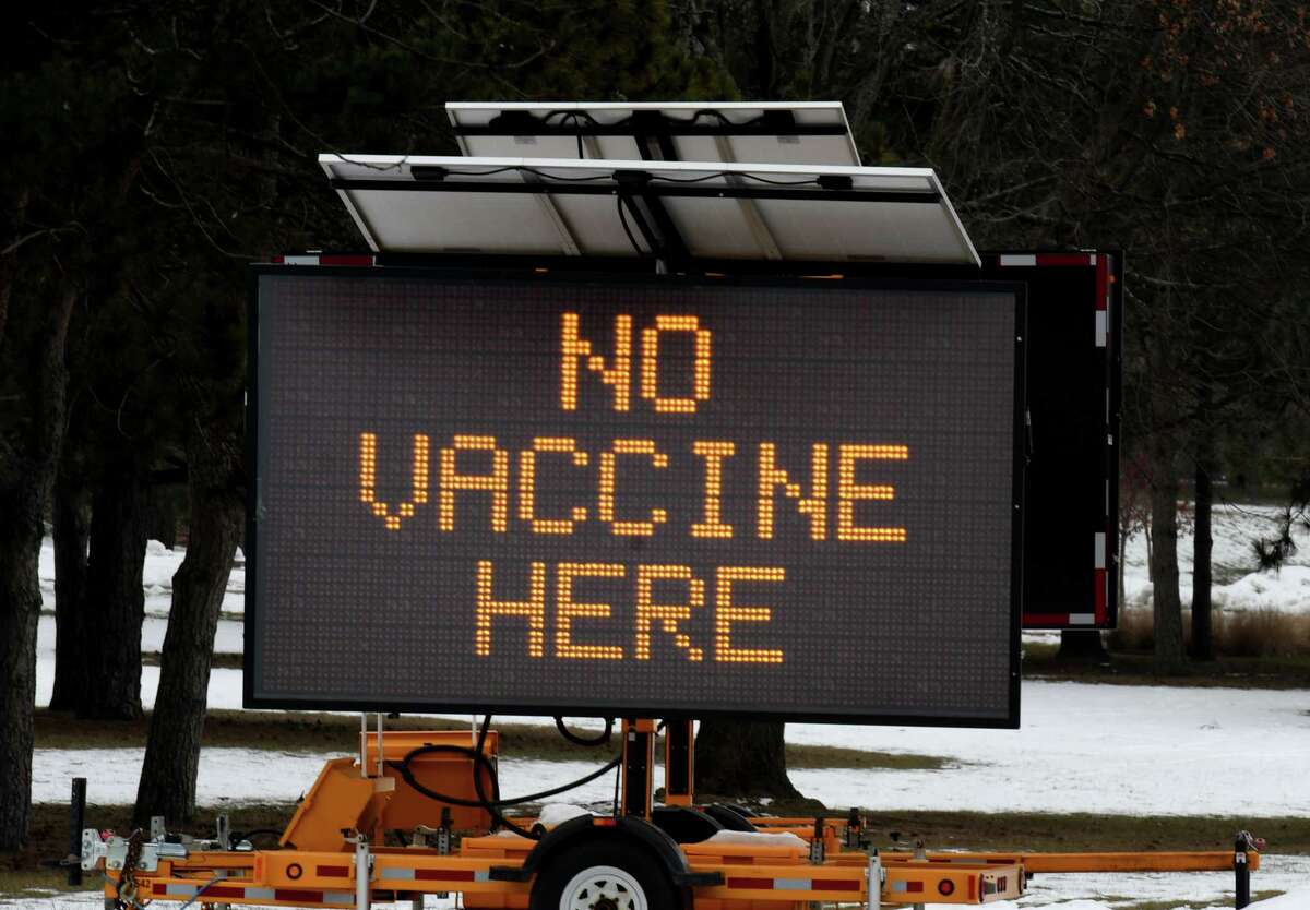 A sign on the University at Albany Campus informs drivers that there is no vaccine at the nearby COVID-19 testing site on Wednesday, Jan. 13, 2021, in Albany, N.Y. A new mass-vaccine distribution center is being built at the Northwest Gold parking lot. (Will Waldron/Times Union)