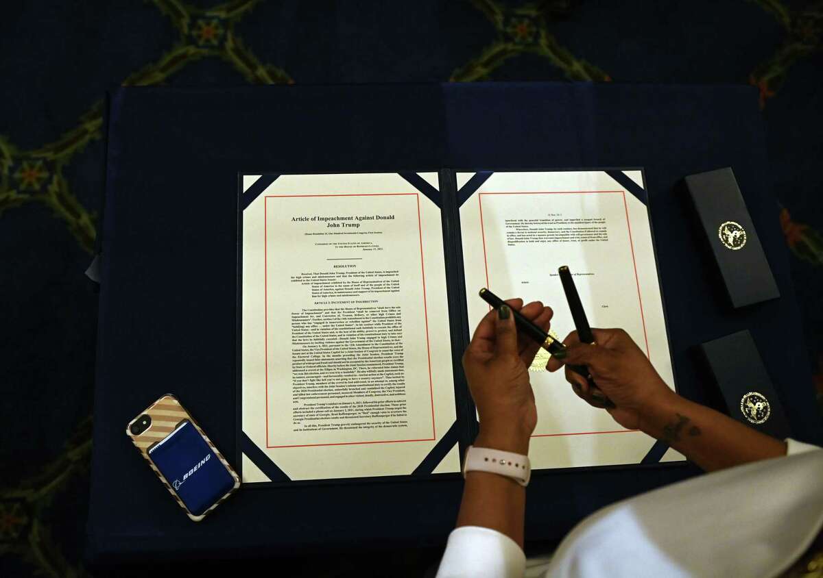 The article of impeachment against US President Donald Trump is pictured during an engrossment ceremony after the US House of Representatives voted to impeach him at the US Capitol, January 13, 2021, in Washington, DC. - Donald Trump on January 13 became the first US president to be impeached for a second time, when a bipartisan majority in the House of Representatives voted to charge him with inciting last week's attack on the US Capitol. (Photo by Brendan SMIALOWSKI / AFP) (Photo by BRENDAN SMIALOWSKI/AFP via Getty Images)