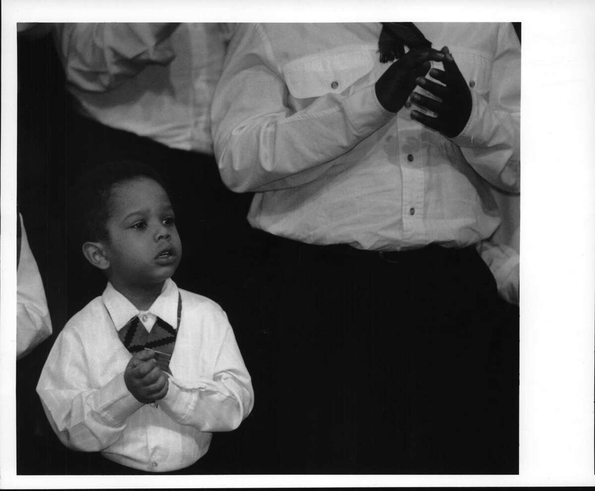 Plaza Convention Center, Albany, New York - Dayshawn Mojica, 3, of Schenectady, sings with the Capital District Mass Youth Choir oat the Martin Luther King day ceremony. January 13, 1993 (Skip Dickstein/Times Union Archive)