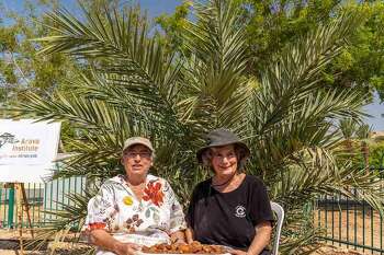 Researchers Dr. Elaine Soloway of the Arava Institute for Environmental Studies, (left), with Dr. Sarah Sallon of Hadassah Medical Center, are pictured moments after recently picking the first harvest of dates on a previous trip for doing so.