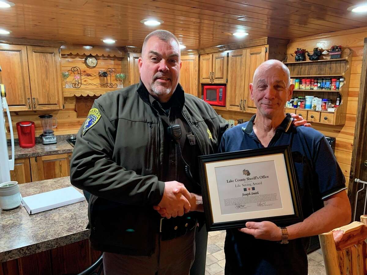Reserve Deputy Joe Smith (right) received a lifesaving award, along with several other members of the Lake County Sheriff's Office, for their efforts in a 2019 incident involving a kayak rescue. (Pioneer file photo)