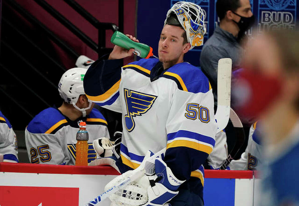 Blues goaltender Jordan Binnington sprays water from his bottle during a timeout in the second period of Wednesday’s season-opening victory over the Colorado Avalanche in Denver.