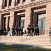 Texas state troopers wearing riot gear stand guard outside the Capitol in Austin, Texas, on Tuesday, Jan. 12, 2021, for the opening of the legislative session. The Texas Department of Public Safety has increased its presence at the state Capitol after last week's deadly attack on the U.S. Capitol by supporters of President Donald Trump. The FBI also has warned of plans for armed protests at all 50 state capitals and in Washington, D.C., in the days leading up to President-elect Joe Biden's inauguration. (AP Photo/Jim Vertuno)