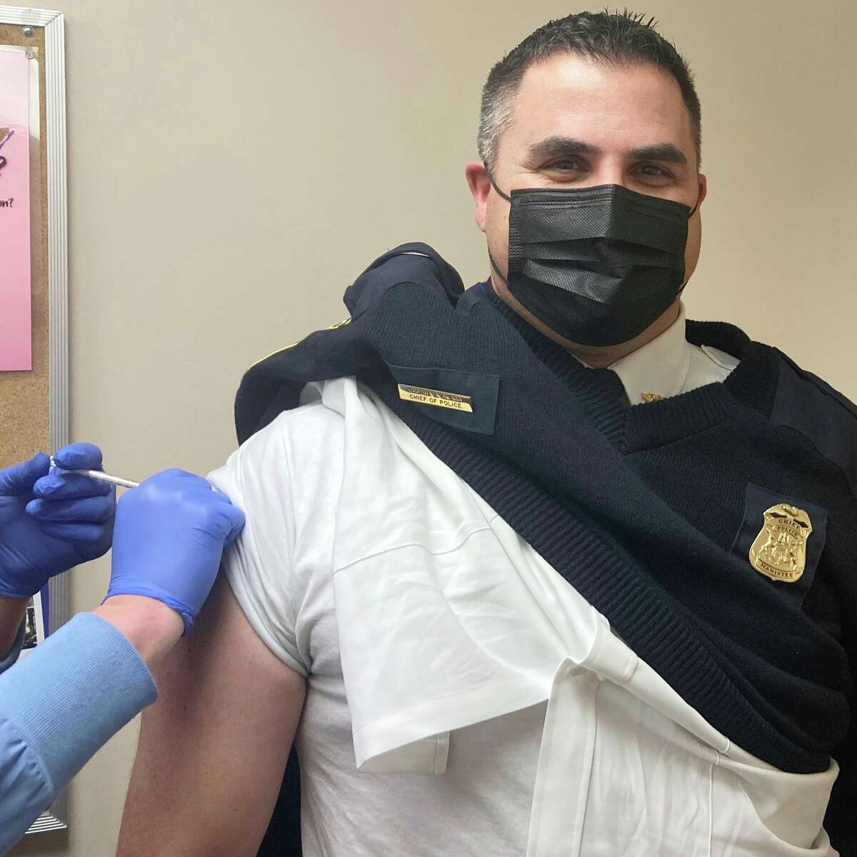 Josh Glass, Manistee City Police chief, smiles behind his mask while getting the second dose of the COVID-19 vaccine on Wednesday. (Courtesy photo)