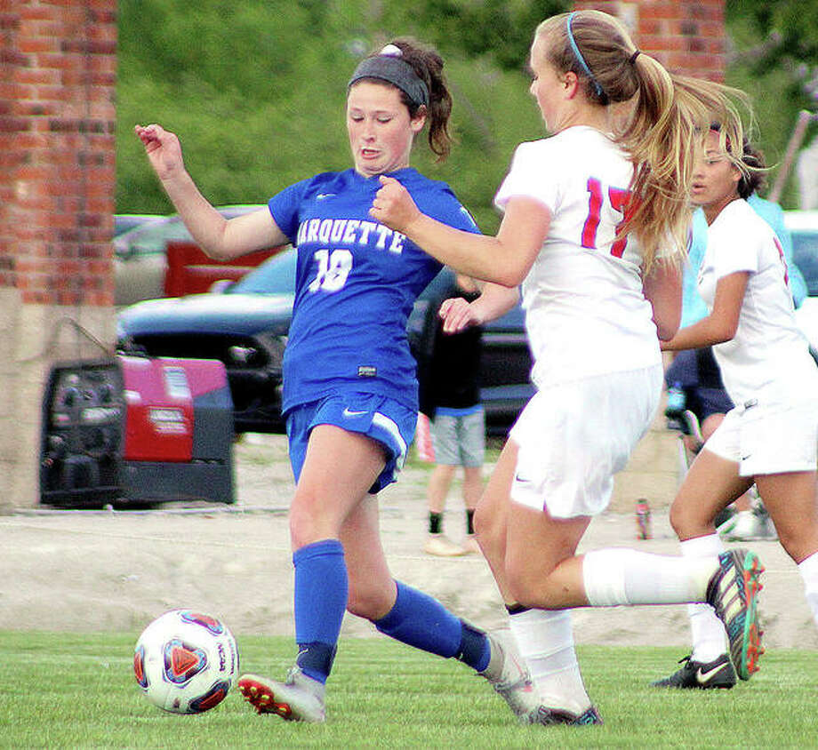 Madelyn Smith of Marquette (18) has announced that she will play soccer next season for Saint Louis University. Above, Smith moves the ball while being marked by Olivia Mouser of Roxana during a 2019 Class 1A regional game. Photo: Pete Hayes | The Telegraph