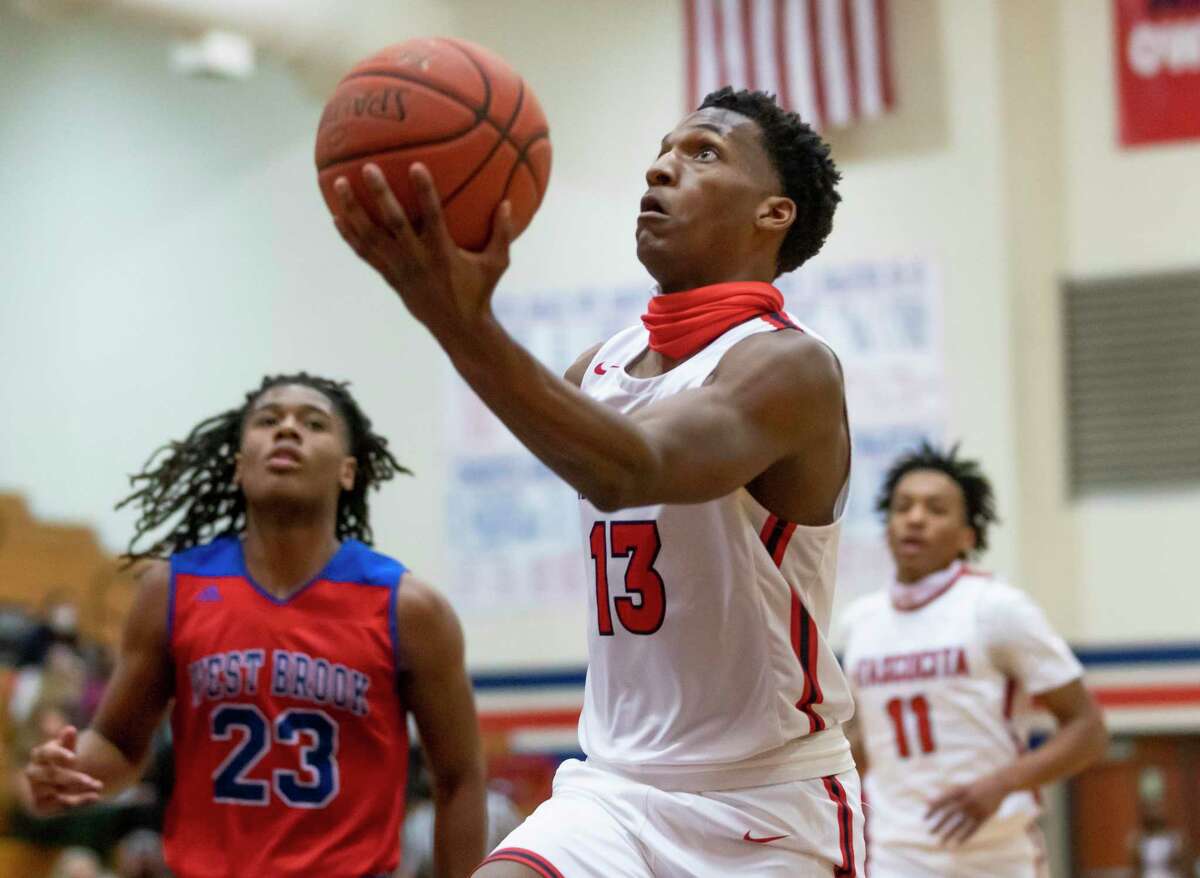 Atascocita point guard Justin Collins (13) jumps toward the basket during the first quarter of a District 21-6A basketball game against Westbrook at Atascocita High School, Wednesday, Jan. 13, 2021, in Humble.
