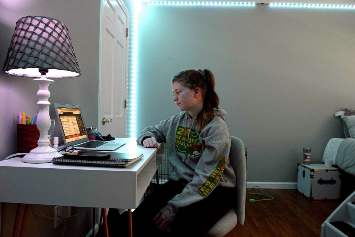 Catherine Quinn, 14, is home full-time distance learning from Danbury High School. Her brother James, 12, is home distance learning three day a week. Wednesday morning, January 13, 2021, in Danbury, Conn.