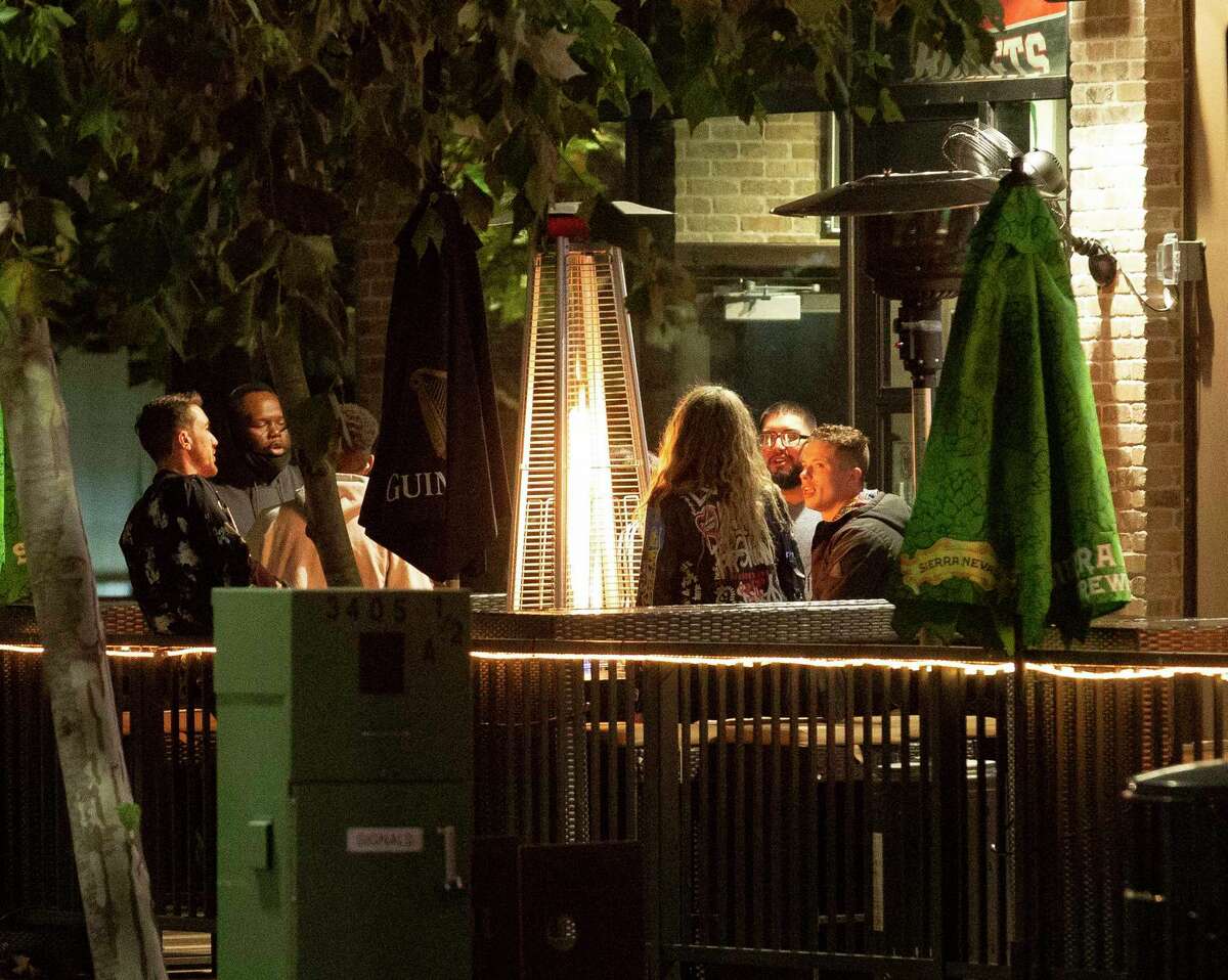 People hangout at a patio of a bar on Holman Street Thursday, Jan. 14, 2021, in Houston.