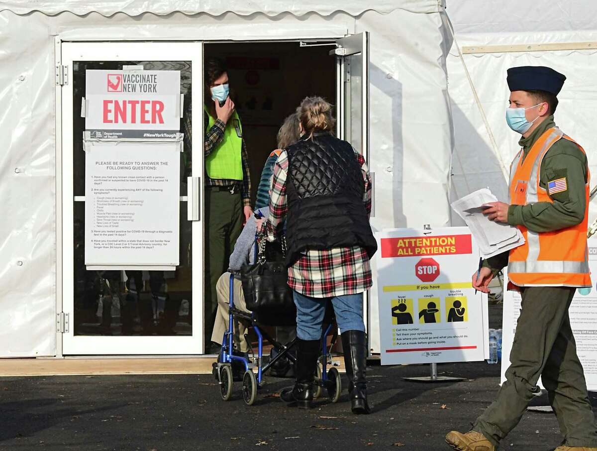 People check in with personnel to receive the COVID-19 vaccine at University at Albany on Friday, Jan. 15, 2021 in Albany, N.Y. The mass-vaccine site opened today at this location. (Lori Van Buren/Times Union)
