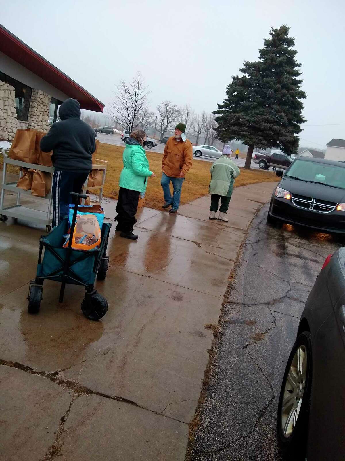 Volunteers distribute bags of essentials at the food pantry held Friday. (Courtesy Photo/Jeanne Barber)