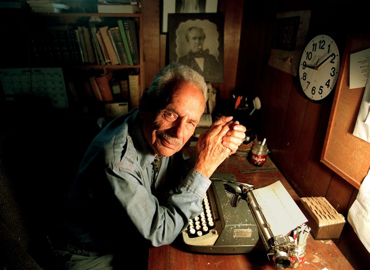 Maury Maverick sits with his typewriter, a photo of Sam Houston in the background, in 2003. The fearless civil rights advocate, legislator, columnist and patriot would have turned 100 today.