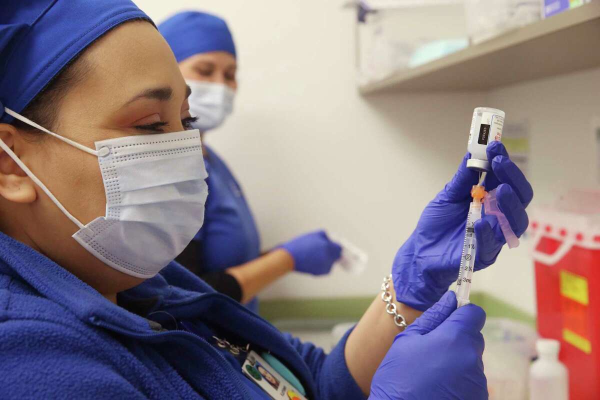 Kathleen Zaragoza fills a syringe with the Moderna COVID vaccine during a mass vaccination at the Wonderland of the Americas Mall. The vaccines are being distributed by University Health and, as more become available, will require an appointment for those who qualify.