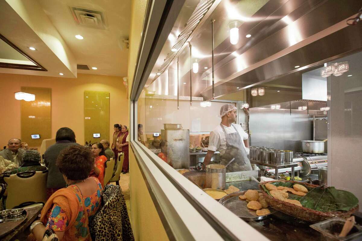 A large window allows diners to watch the traditional roti and poori breads being prepared on Nov. 16, 2012 at Maharaja Bhog restaurant in Houston, Texas.