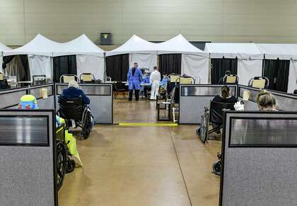 COVID-19 patients who have received infusions of antibodies wait at the Freeman Coliseum complex on Friday, Jan. 15, 2021.