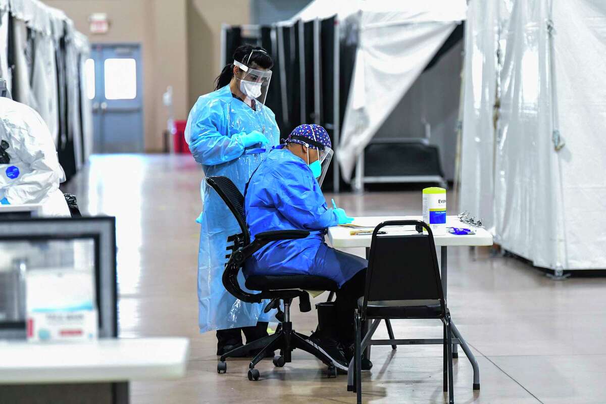 Medical personnel sort through information at the Freeman Coliseum complex on Jan. 15, 2021, where COVID-19 patients were being given infusions of antibodies.