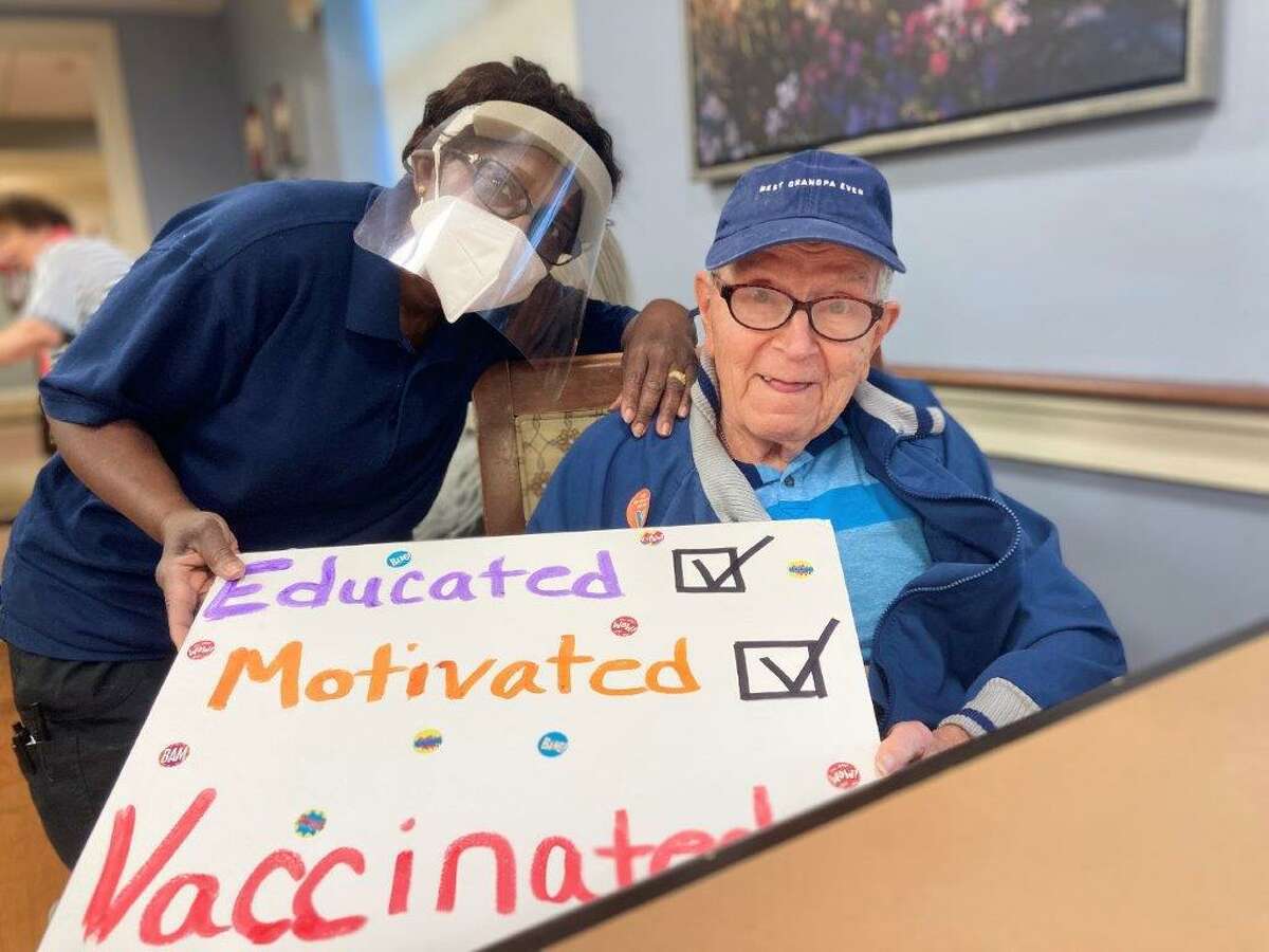 Benchmark Senior Living at Split Rock resident care associate Virginia Toussaint and facility resident Frank Hmelovsky on Wednesday, Jan. 13. Residents and staff at the facility received the COVID-19 vaccine that day.