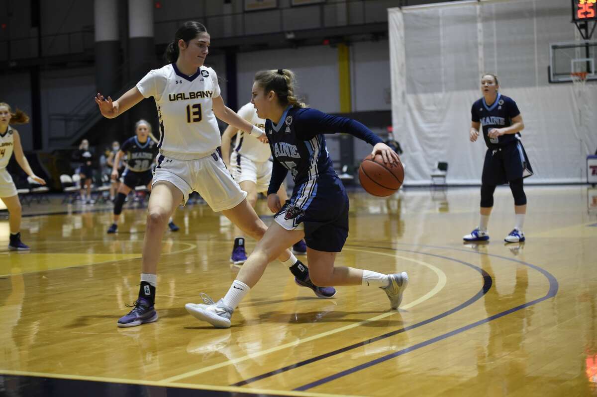 Maine guard Dor Saar dribbles behind her back as she tries to elude UAlbany defender Lucia Descortes in an America East women's basketball game Saturday, Jan. 16, 2021, at SEFCU Arena in Albany. (Kathleen Helman/UAlbany athletics)