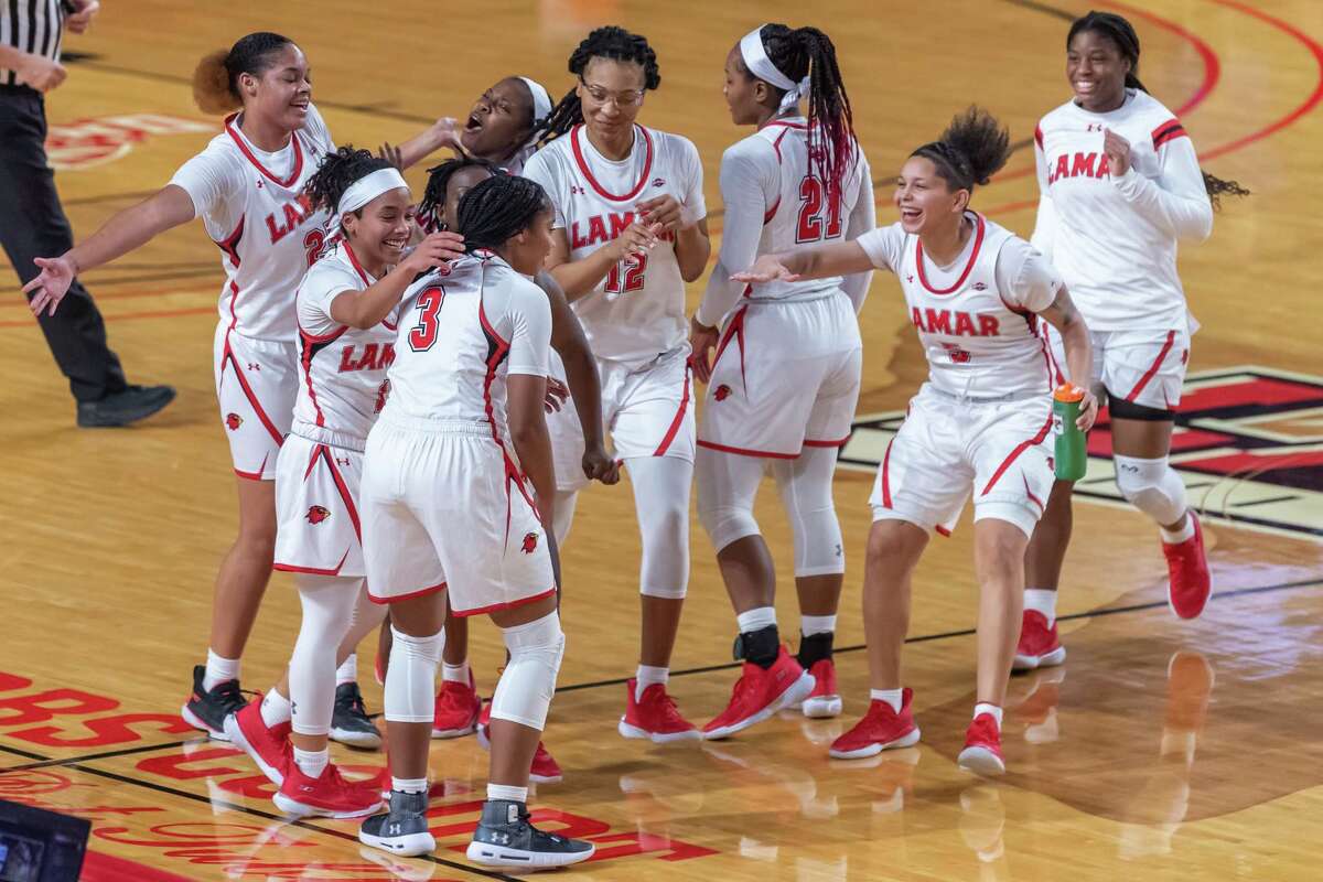 The team comes out to congratulate Sabria Dean (3) on her buzzer-beating basket to end the first half. The Lamar Lady Cardinals downed the Tarleton State TexAnns in their home openier Saturday afternoon at the Montagne Center. Photo made on December 5, 2020. Fran Ruchalski/The Enterprise