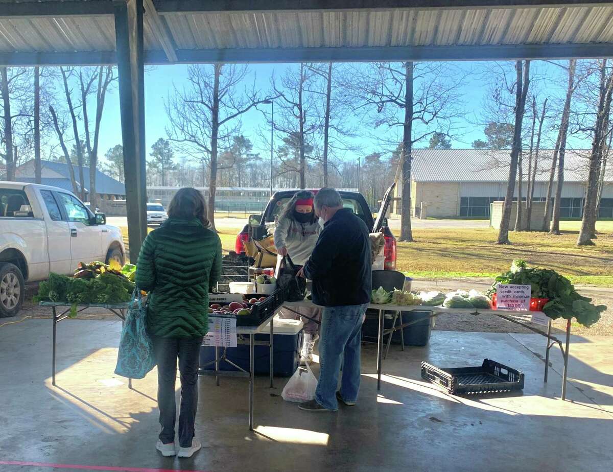 Shoppers buying local fresh produce at the Beaumont Farmers' market on Saturday, Jan. 16, 2021 at the Beaumont Athletic Complex in Beaumont, TX. The Enterprise/ Ramos