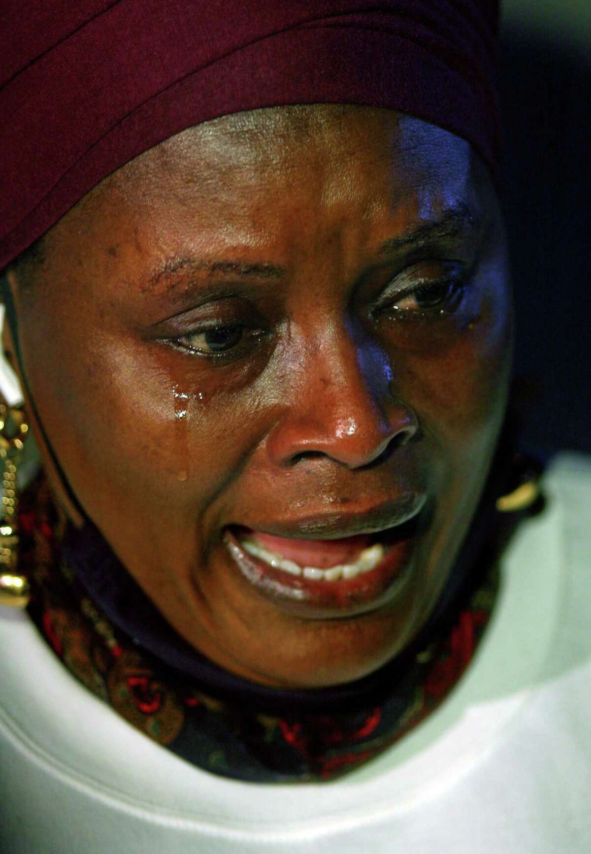 Mubarak Soulemane's mother Imo Mohammed sheds a tear as she speaks to the media at the start of a vigil for Soulemane at the I95 overpass along Campbell Avenue in West Haven, Conn., on Friday Jan. 15, 2021. Soulemane, a New Haven resident, was fatally shot by state Trooper Brian North after a car chase on Jan. 15, 2020.