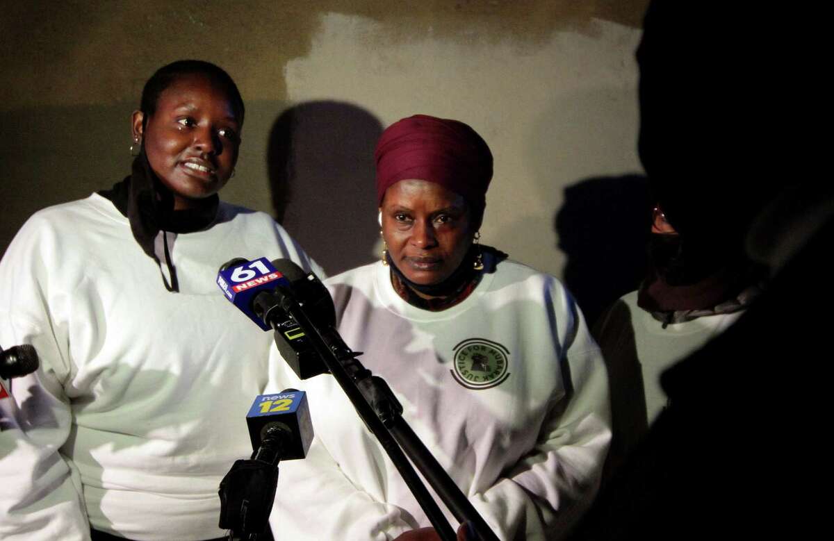 Mubarak Soulemane's sister Mariyann Soulemane, left, and his mother Imo Mohammed speak to the media at the start of a vigil for Soulemane at the I95 overpass along Campbell Avenue in West Haven, Conn., on Friday Jan. 15, 2021. Soulemane, a New Haven resident, was fatally shot by state Trooper Brian North after a car chase on Jan. 15, 2020.