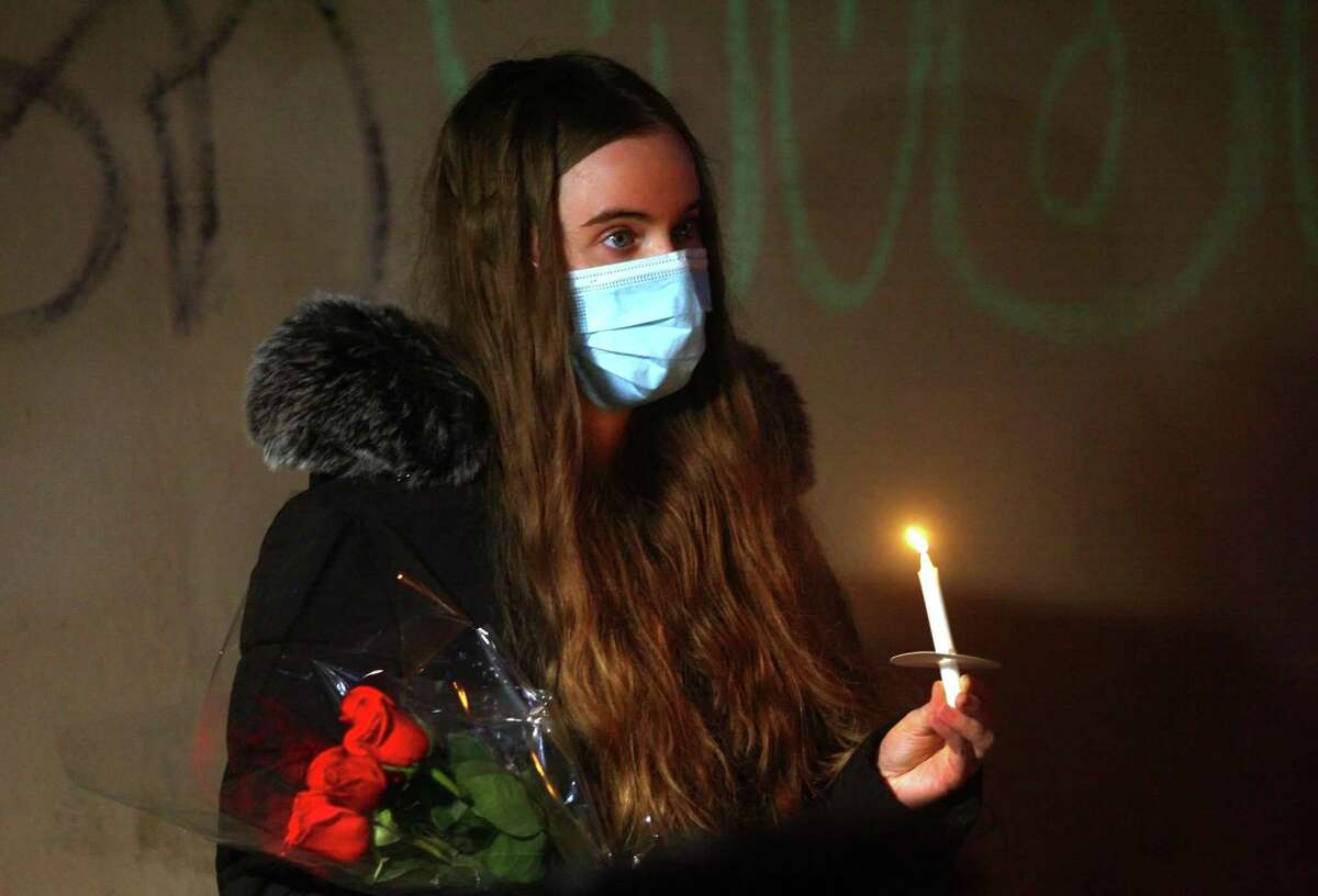 Amelia Sullivan attends a vigil held in memory of his friend Mubarak Soulemane at the I95 overpass along Campbell Avenue in West Haven, Conn., on Friday Jan. 15, 2021. Soulemane, a New Haven resident, was fatally shot by state Trooper Brian North after a car chase on Jan. 15, 2020.