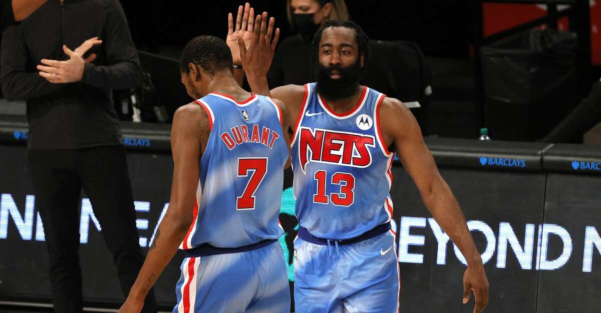 James Harden #13 high-fives Kevin Durant #7 of the Brooklyn Nets during the first half against the Orlando Magic at Barclays Center on January 16, 2021 in the Brooklyn borough of New York City. (Photo by Sarah Stier/Getty Images)