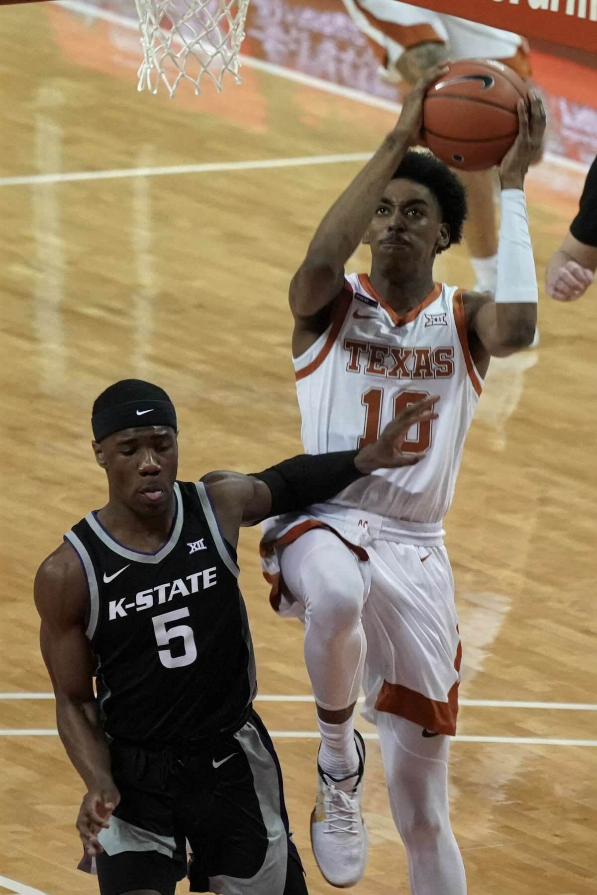 Texas' Donovan Williams (10) drives against Kansas State's Rudi Williams (5) during the first half of an NCAA college basketball game in Austin, Texas, Saturday, Jan. 16, 2021. (AP Photo/Chuck Burton)