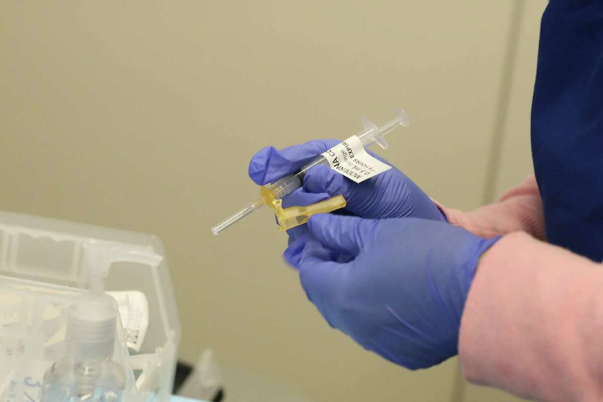 Medical assistant Lori Viramontes prepares a Moderna vaccination for a patient at the coronavirus clinic at Sutter Health in San Francisco. Sutter Health is vaccinating adults 75 and older.