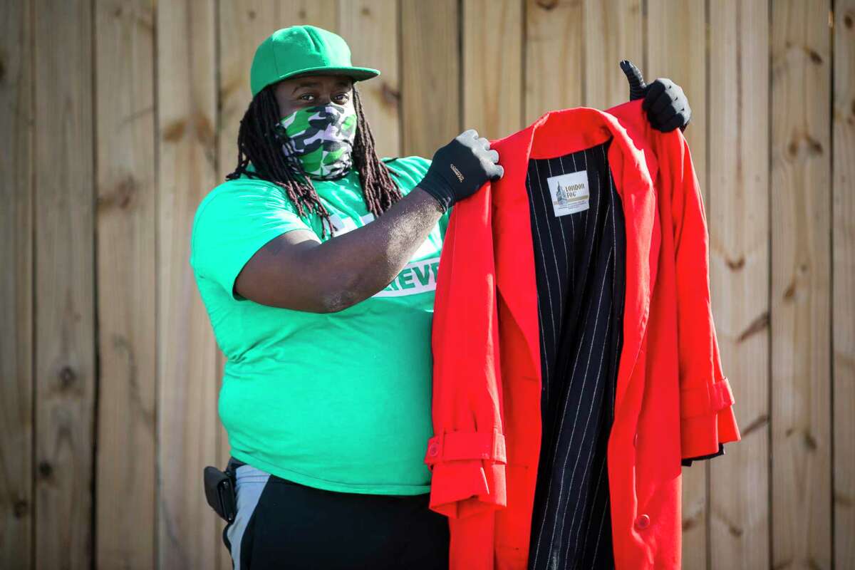 Jasaul Yeldell, also known as Jsqually on social media platforms, helps members of the Community of Faith Church and Good Gang USA hand out over 2,000 coats to community members in north Houston on Sunday, Jan. 17, 2021.