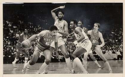 Joe Barry Carroll, with arm raised defending Julius Irving, scored more than 10,000 points in his career.