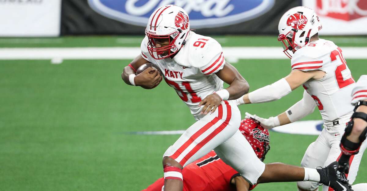 Katy defensive lineman Cal Varner (91) runs over Cedar Hill quarterback Kaidon Salter (7) as he returns an interception of a Salter pass 15 yards for a touchdown during the fourth quarter of the Class 6A Division II UIL State Championship high school football game at AT&T Stadium Saturday, Jan. 16, 2021, in Arlington, Texas. Katy captured the championship with a 51-14 win over Cedar Hill.